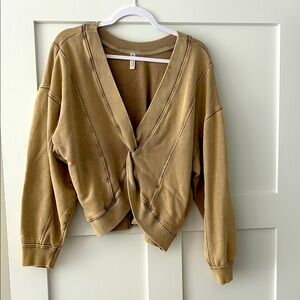 Free People fp movement Tan V-Neck Twist Front Sweatshirt with side pockets.